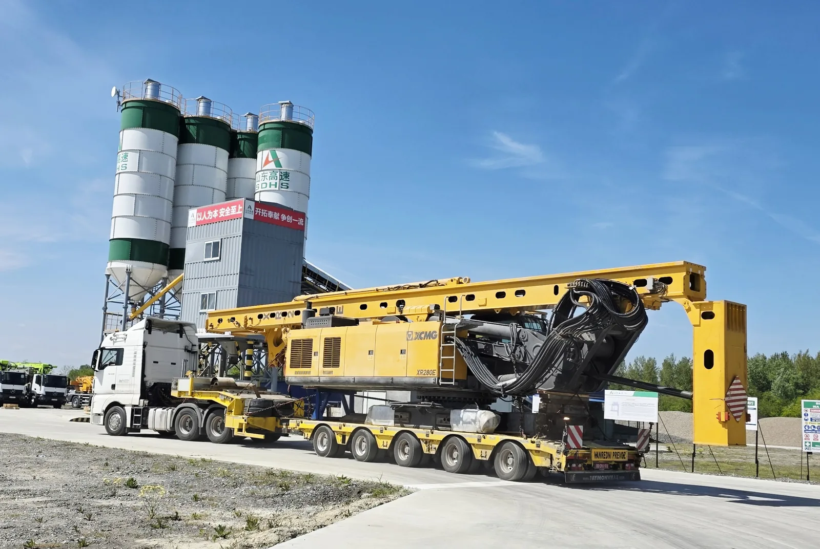 XCMG XR280E rotary drilling rig transported on a multi-axle lowboy trailer