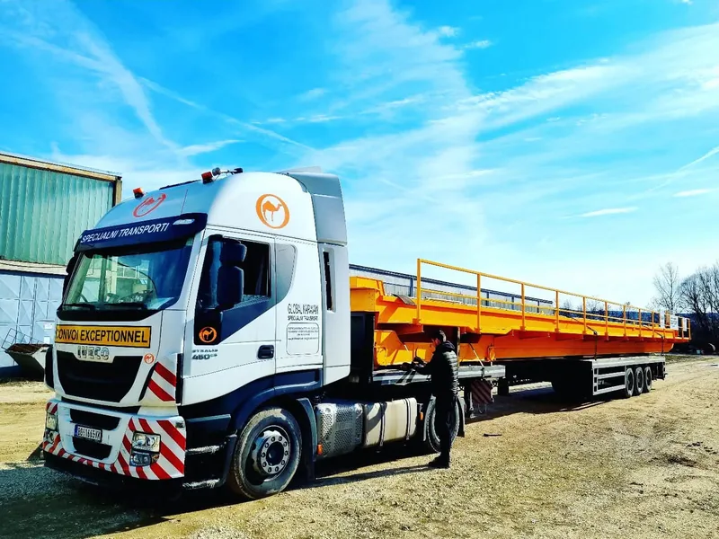 Iveco truck marked Convoi Exceptionnel hauling a steel crane girder